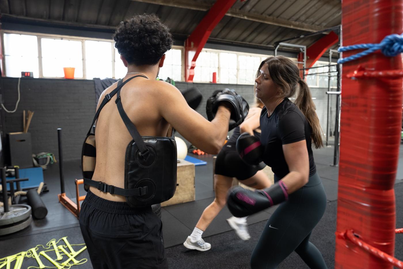 Member on the pads with a coach
